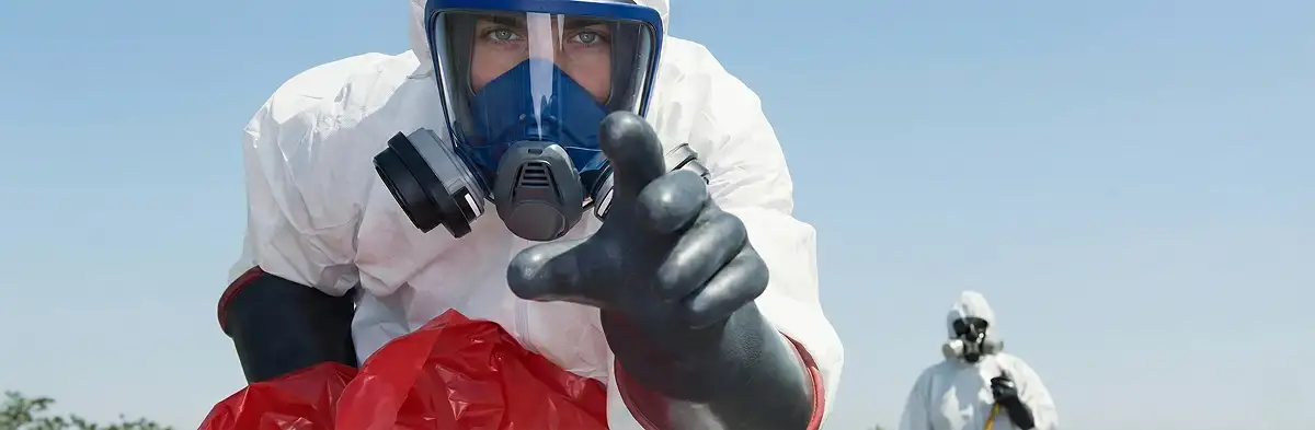 sewage clean up technician wearing protective gear handling biohazard materials in Albany, NY
