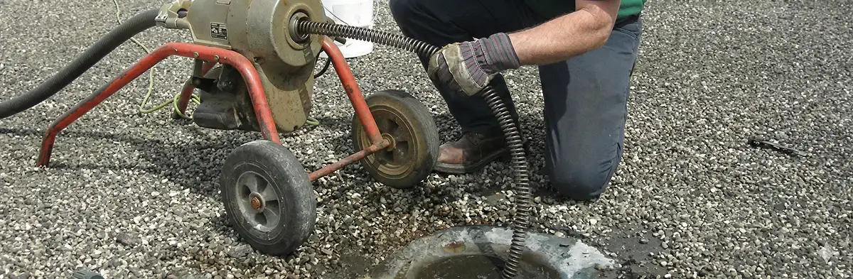 sewer rodding technician actively removing blockages from a sewer line in Albany, NY